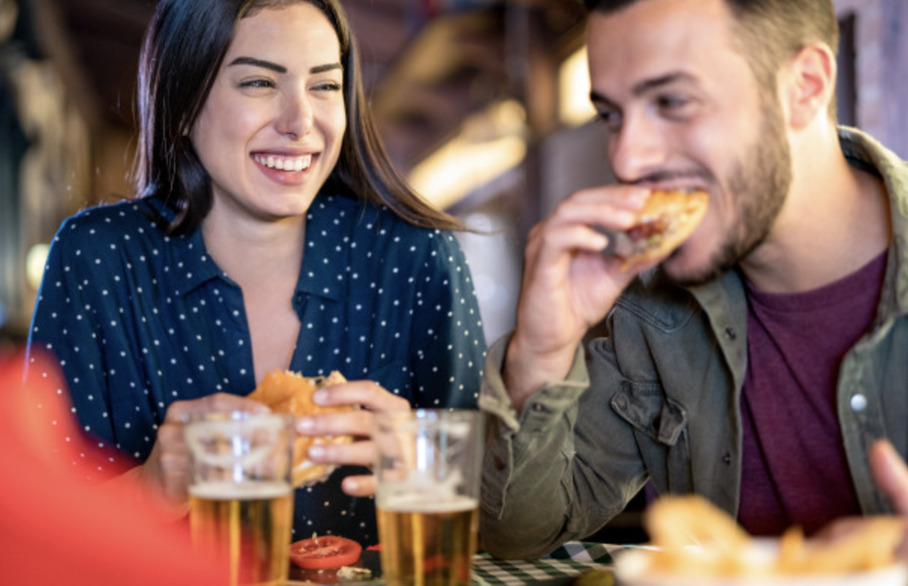 Couple eating a burger at a pub