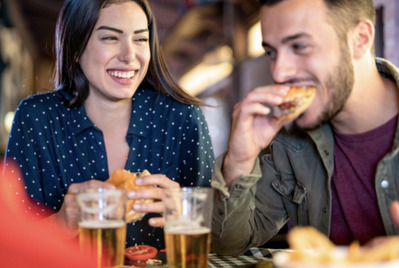 Couple eating a burger at a pub