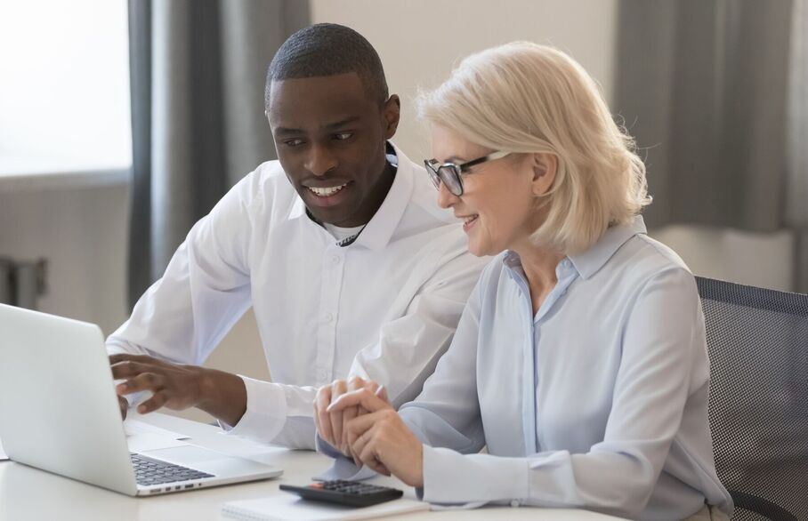 Two people looking at a laptop