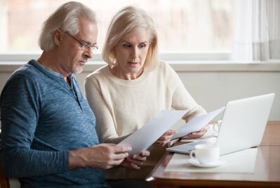 Two people looking at a piece of paper