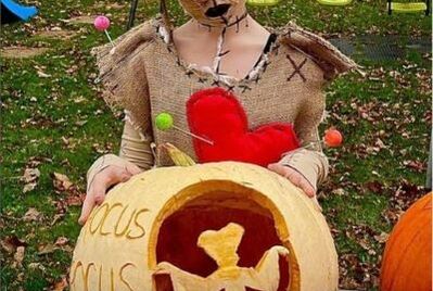 Winner of pumpkin carving competition dressed in a halloween costume