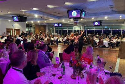 A dancefloor surrounded by tables at the Summer Charity Ball