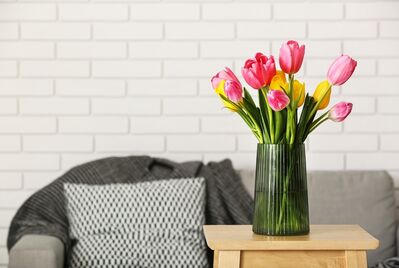 The front of a house surrounded by flowers