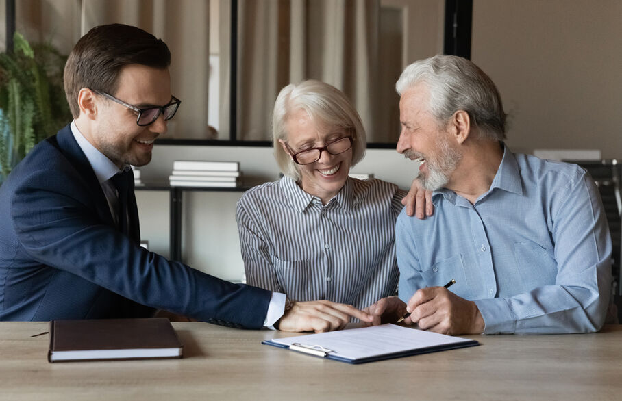 An older couple talking with an estate agent