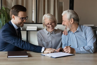 An older couple talking with an estate agent