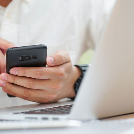 Hand holding mobile checking alert notification