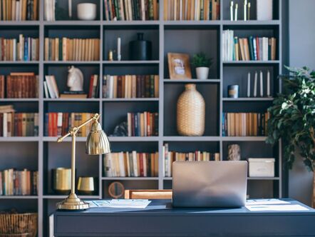 A study with a bookshelf and laptop