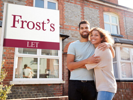 A young couple standing in front of a Frost