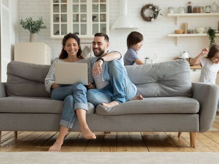 A couple sitting in front of a laptop