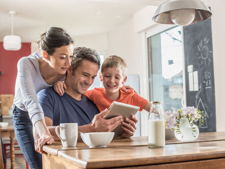 Happy family looking at a tablet