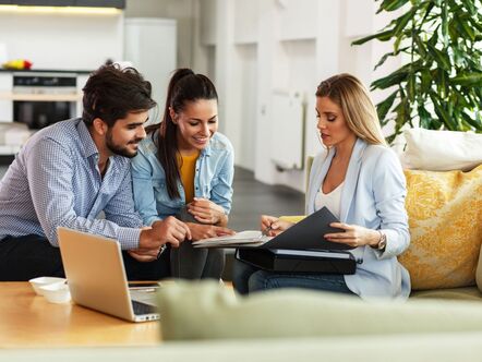 An estate agent speaking to a young couple